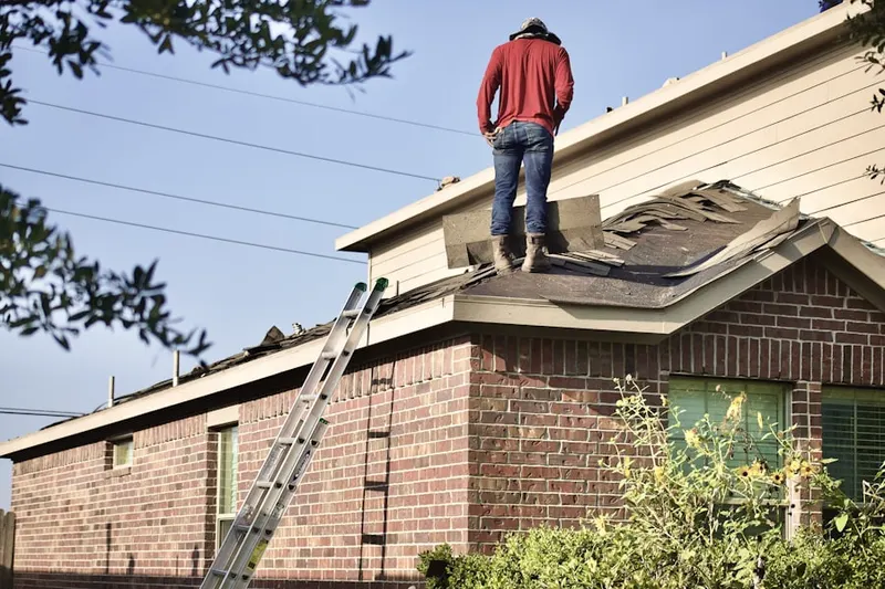 Professional roofer working on a residential roof in Cherokee Park